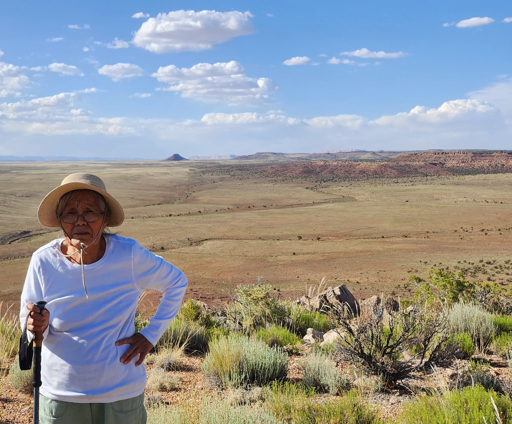 Yellowhair's mother stands with 'Missing Tooth Rock' in the distance